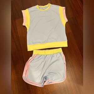 Matching Shirt/Short set. Never worn. Size Small. Light blue, purple & lime trim
